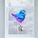 Evening Song crystal suncatcher perching in a bright window ready to scatter rainbows

