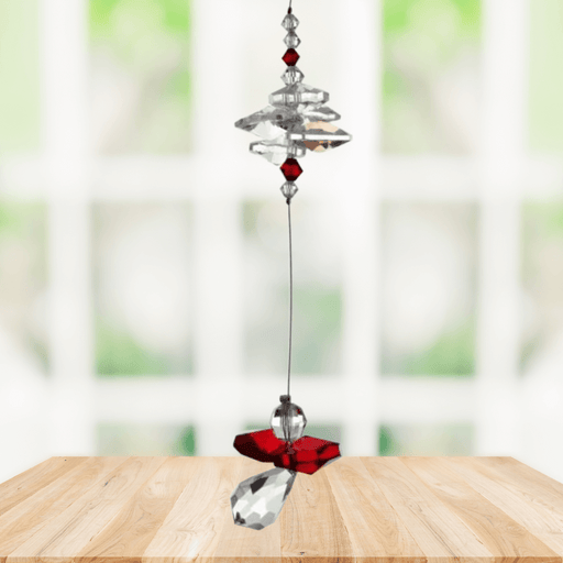 Garnet guardian angel crystal cascade suncatcher hanging in a bright window