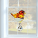 Goldfinch crystal suncatcher hanging in a sunlit window, ready to scatter warm rainbows

