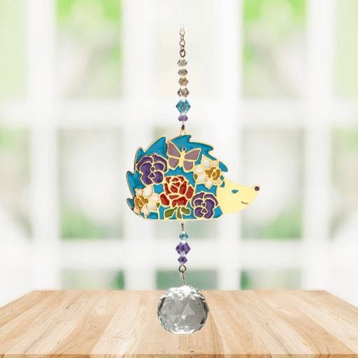 Wild Things Hedgehog multicolour crystal suncatcher hanging in a window with crystal beads and clear faceted prism
