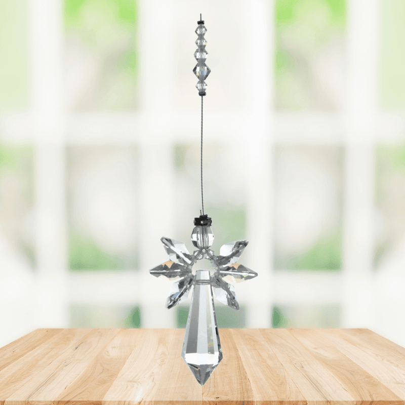 Large aurora borealis guardian angel crystal suncatcher hanging in a bright window