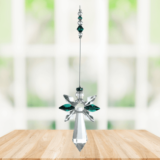 Large emerald guardian angel crystal suncatcher hanging in a bright window
