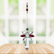 Large garnet guardian angel crystal suncatcher hanging in a bright window