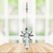 Large light amethyst guardian angel crystal suncatcher hanging in a bright window