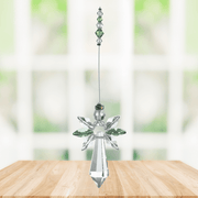 Large peridot guardian angel crystal suncatcher hanging in a bright window
