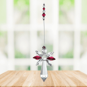 Large ruby guardian angel crystal suncatcher hanging in a bright window