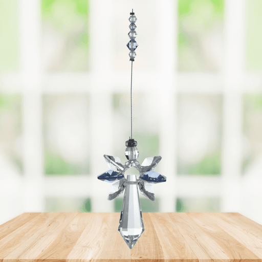 Large sapphire guardian angel crystal suncatcher hanging in a bright window