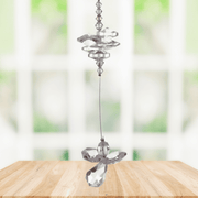 Light amethyst guardian angel crystal cascade suncatcher hanging in a bright window