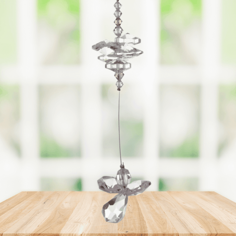 Light amethyst guardian angel crystal cascade suncatcher hanging in a bright window