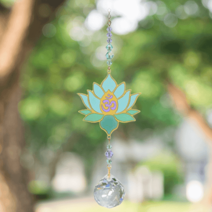 Lotus Aurora Crystal Suncatcher catching garden light – serene lotus flower, Om centre, pastel bead cascade and 20 mm prism scattering rainbows.


