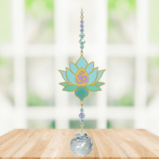 Lotus Aurora Crystal Suncatcher hanging in a sunny window; aqua-mint lotus motif, lavender-teal beads and sparkling crystal ball.
