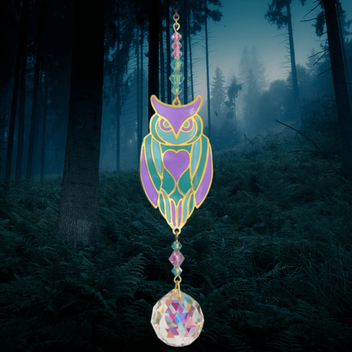 Owl Aurora Crystal Suncatcher against moonlit forest – turquoise-purple owl, gemstone bead cascade and 20 mm prism scattering rainbow light.


