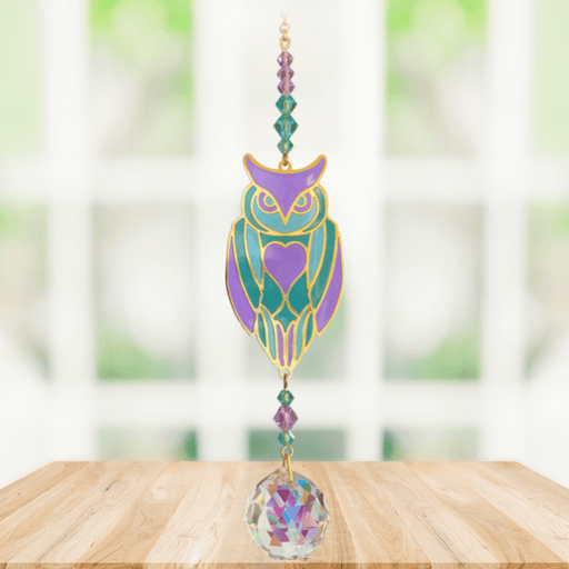 Owl Aurora Crystal Suncatcher hanging in a bright window; pastel owl motif, amethyst-emerald beads and sparkling crystal ball.
