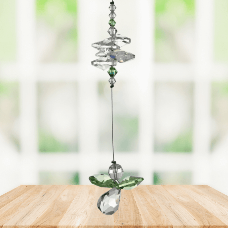 Peridot guardian angel crystal cascade suncatcher hanging in a bright window