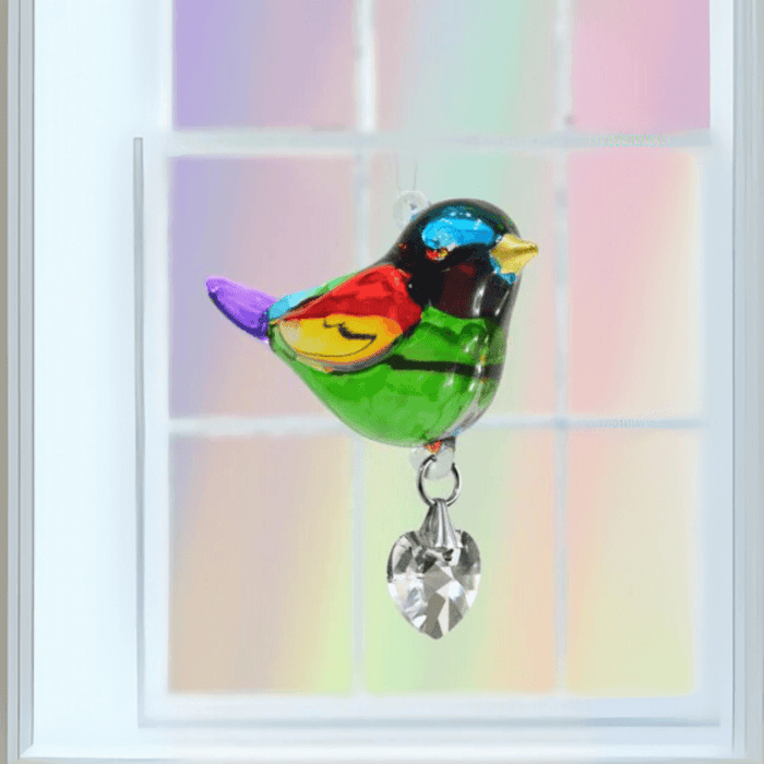 Rainbow crystal bird suncatcher hanging in a bright window, ready to cast rainbow light

