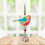 Robin Crystal Suncatcher hanging in a bright window; colourful robin motif, red-green beads and sparkling crystal ball.
