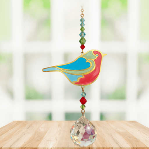 Robin Crystal Suncatcher hanging in a bright window; colourful robin motif, red-green beads and sparkling crystal ball.
