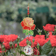 Rose Crystal Suncatcher among garden roses – enamel flower, jewel-tone bead cascade and 20 mm prism scattering rainbow light.

