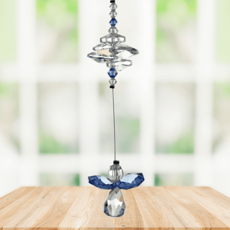 Sapphire guardian angel crystal cascade suncatcher hanging in a bright window