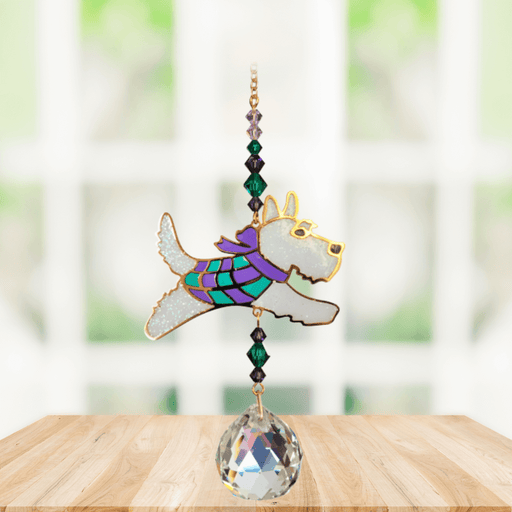 Scottie Dog Crystal Suncatcher hanging in a bright window; sparkling Scottie with tartan-style scarf, emerald-amethyst beads and shining crystal ball.
