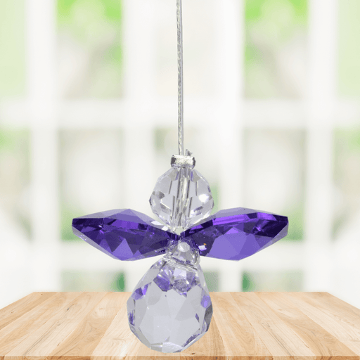 Small amethyst guardian angel Swarovski crystal suncatcher sparkling in a bright window