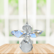 Small aurora borealis guardian angel crystal suncatcher sparkling in a bright window
