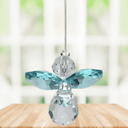 Small blue zircon guardian angel Swarovski crystal suncatcher sparkling in a bright window