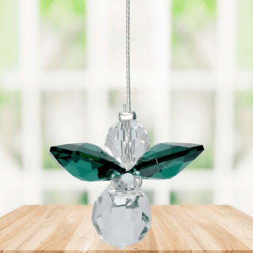 Small emerald guardian angel Swarovski crystal suncatcher sparkling in a bright window