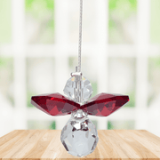 Small garnet guardian angel Swarovski crystal suncatcher sparkling in a bright window