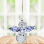 Small light amethyst guardian angel Swarovski crystal suncatcher sparkling in a bright window