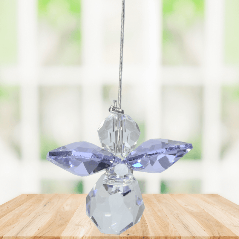 Small light amethyst guardian angel Swarovski crystal suncatcher sparkling in a bright window