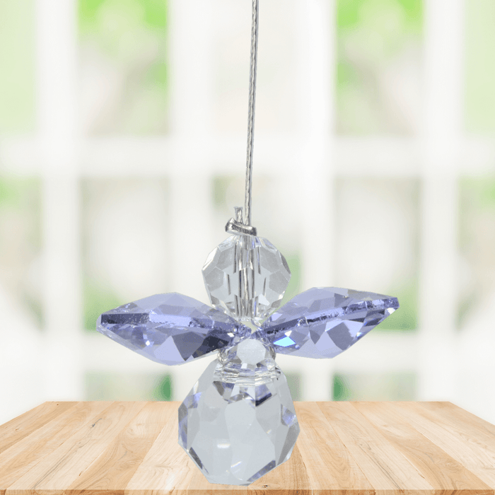 Small light amethyst guardian angel Swarovski crystal suncatcher sparkling in a bright window