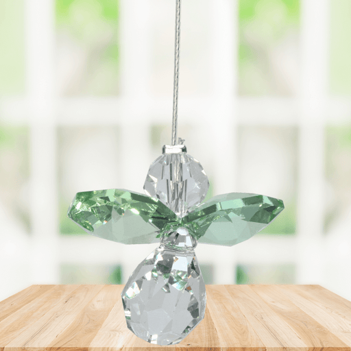 Small peridot guardian angel crystal suncatcher sparkling in a bright window