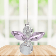 Small rose guardian angel Swarovski crystal suncatcher sparkling in a bright window
