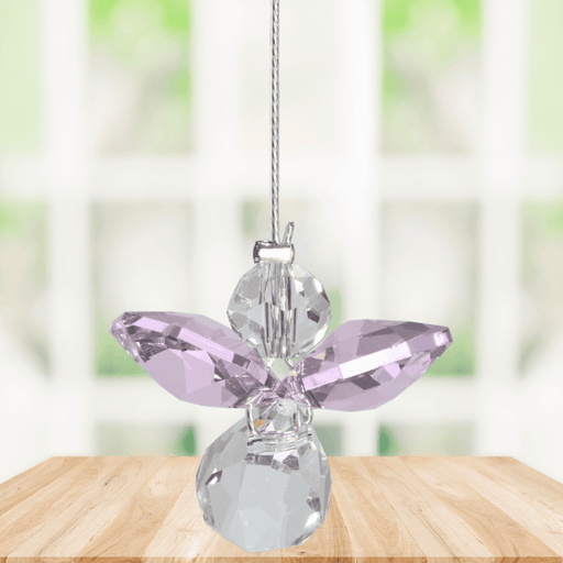 Small rose guardian angel Swarovski crystal suncatcher sparkling in a bright window