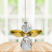 Small topaz guardian angel crystal suncatcher sparkling in a bright window