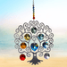 Large Tree of Life Chakra crystal suncatcher sparkling against a calm seaside horizon

