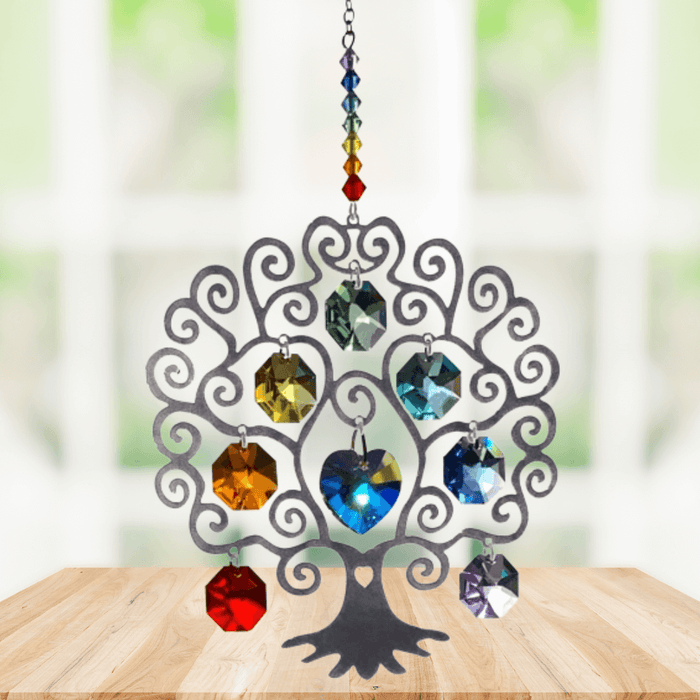 Tree of Life Chakra large suncatcher with rainbow crystals displayed on a wooden table

