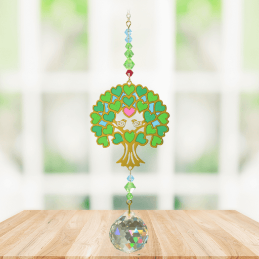 Tree of Life Green Crystal Suncatcher hanging in a bright window; heart-shaped foliage, gemstone-tone beads and sparkling crystal ball.
