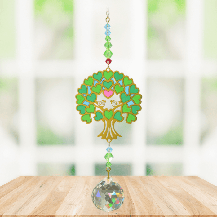 Tree of Life Green Crystal Suncatcher hanging in a bright window; heart-shaped foliage, gemstone-tone beads and sparkling crystal ball.
