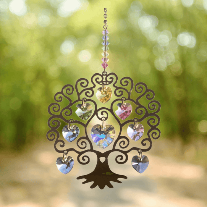 Tree of Life summer crystal suncatcher sparkling in sunlight against a leafy woodland path

