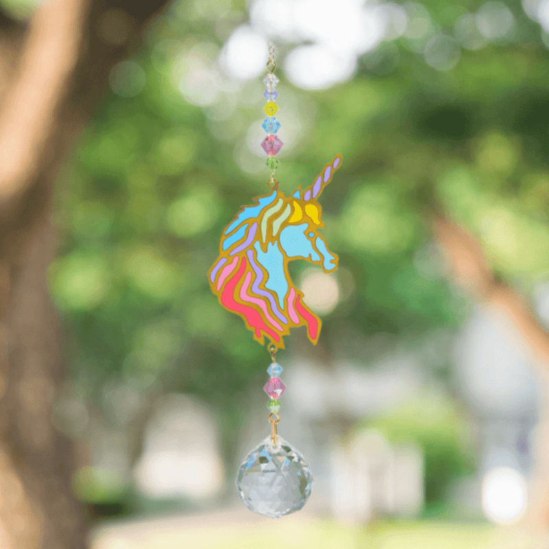 Unicorn Confetti Crystal Suncatcher twinkling outdoors – rainbow-flowing mane, pastel bead cascade and 20 mm prism scattering rainbow light.

