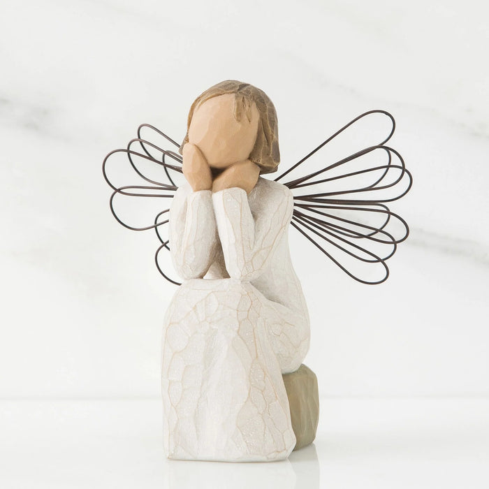 Willow Tree Angel of Caring Figurine with wire wings on a marble background