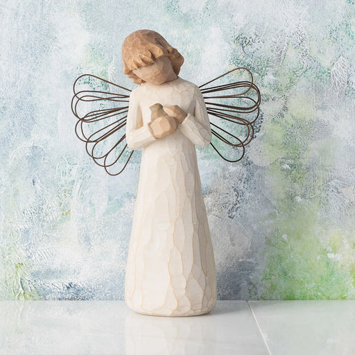 Willow Tree Angel of Healing Figurine in front of pastel textured background