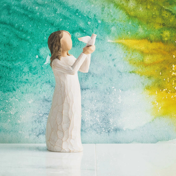 Willow Tree Soar figurine with a painted background in blue and yellow tones