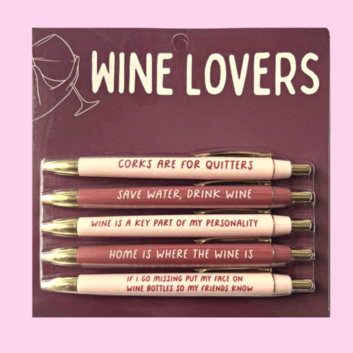 Wine Lovers pen set on maroon backing card with 5 black-ink ballpoint pens in blush and merlot tones, each printed with funny wine phrases.