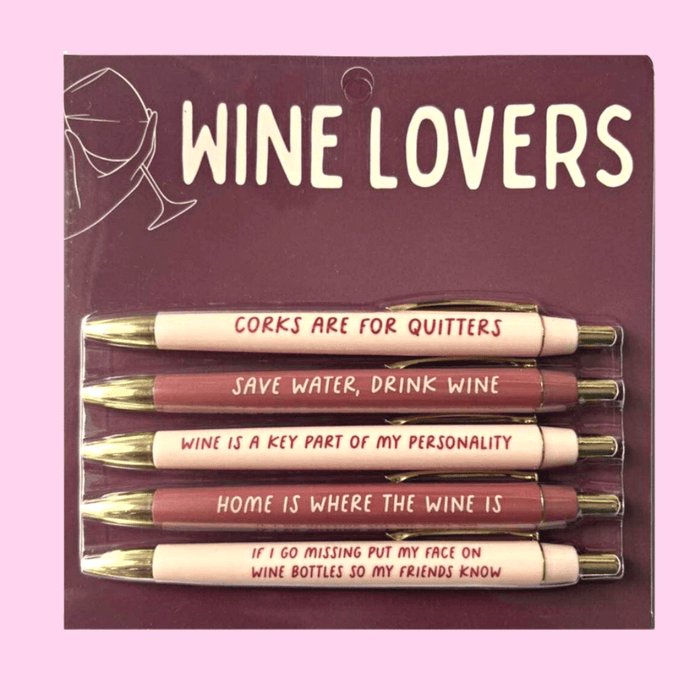 Wine Lovers pen set on maroon backing card with 5 black-ink ballpoint pens in blush and merlot tones, each printed with funny wine phrases.