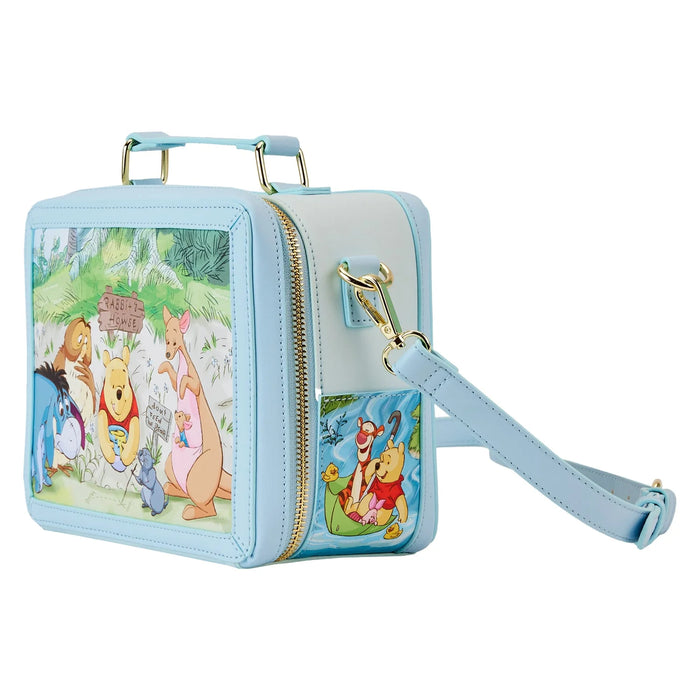 Side panel of crossbody featuring Pooh and Tigger paddling with ducks in a leaf boat