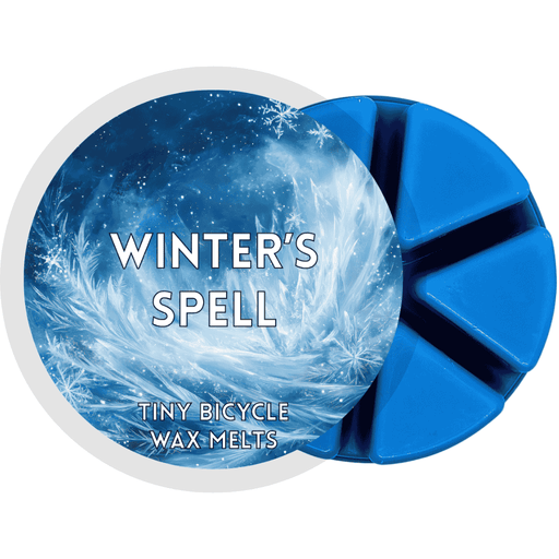 Winter’s Spell wax melt with icy blue frost and swirling snowflake design.
