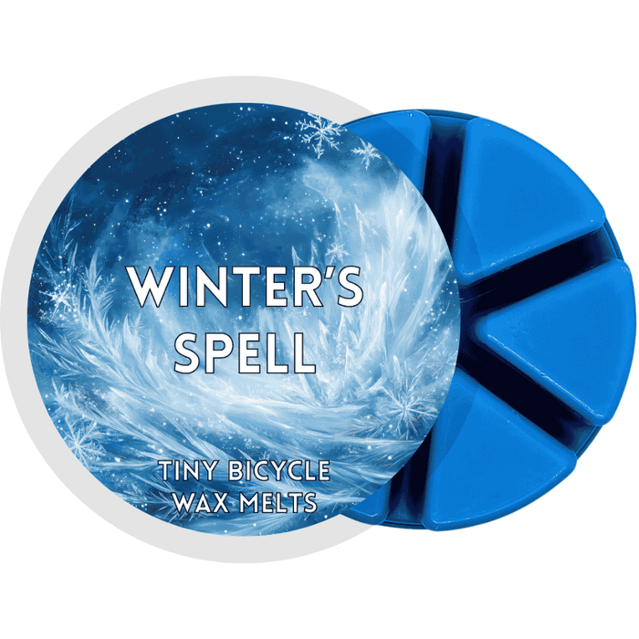 Winter’s Spell wax melt with icy blue frost and swirling snowflake design.